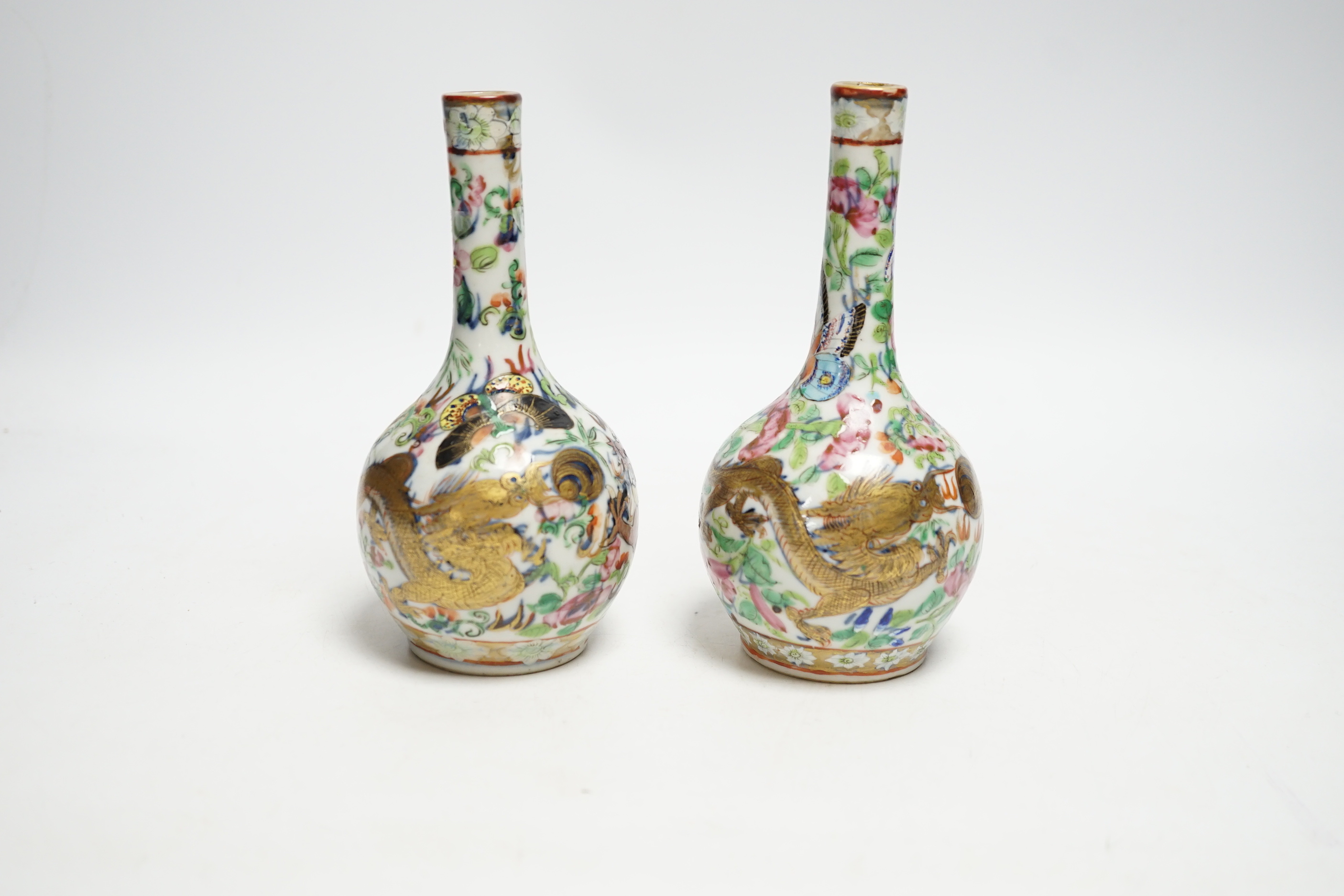 A pair of 19th century Chinese clobbered famille rose 'dragon' bottle vases, 15.5cm